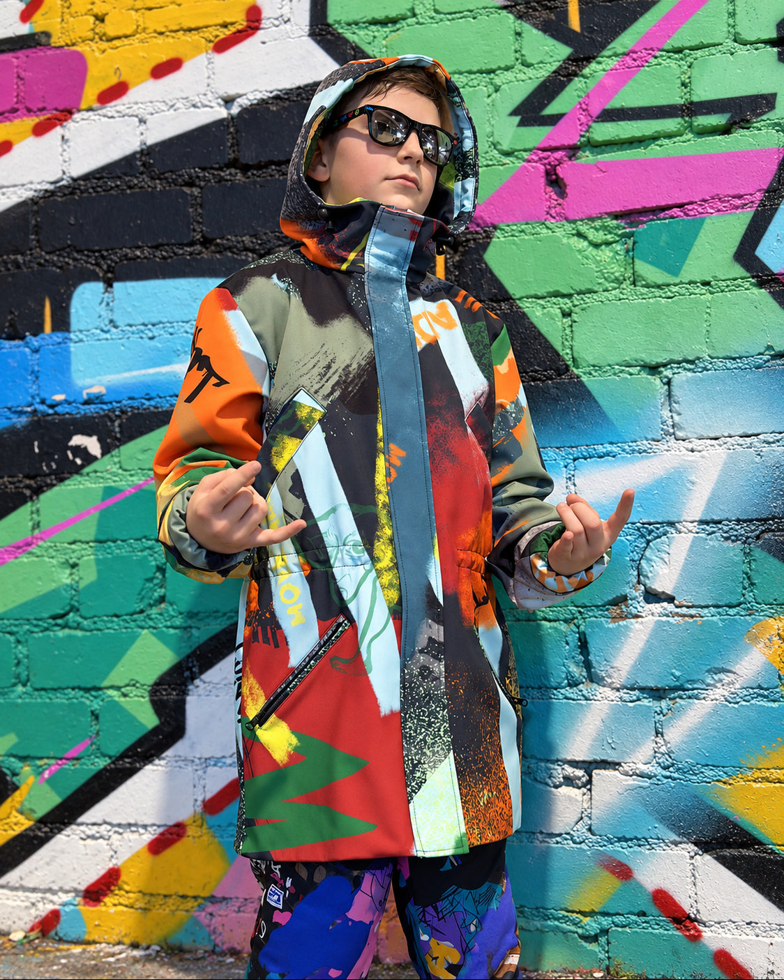 Child wearing MoveAddict Green Graffiti print kids' winter parka - front view