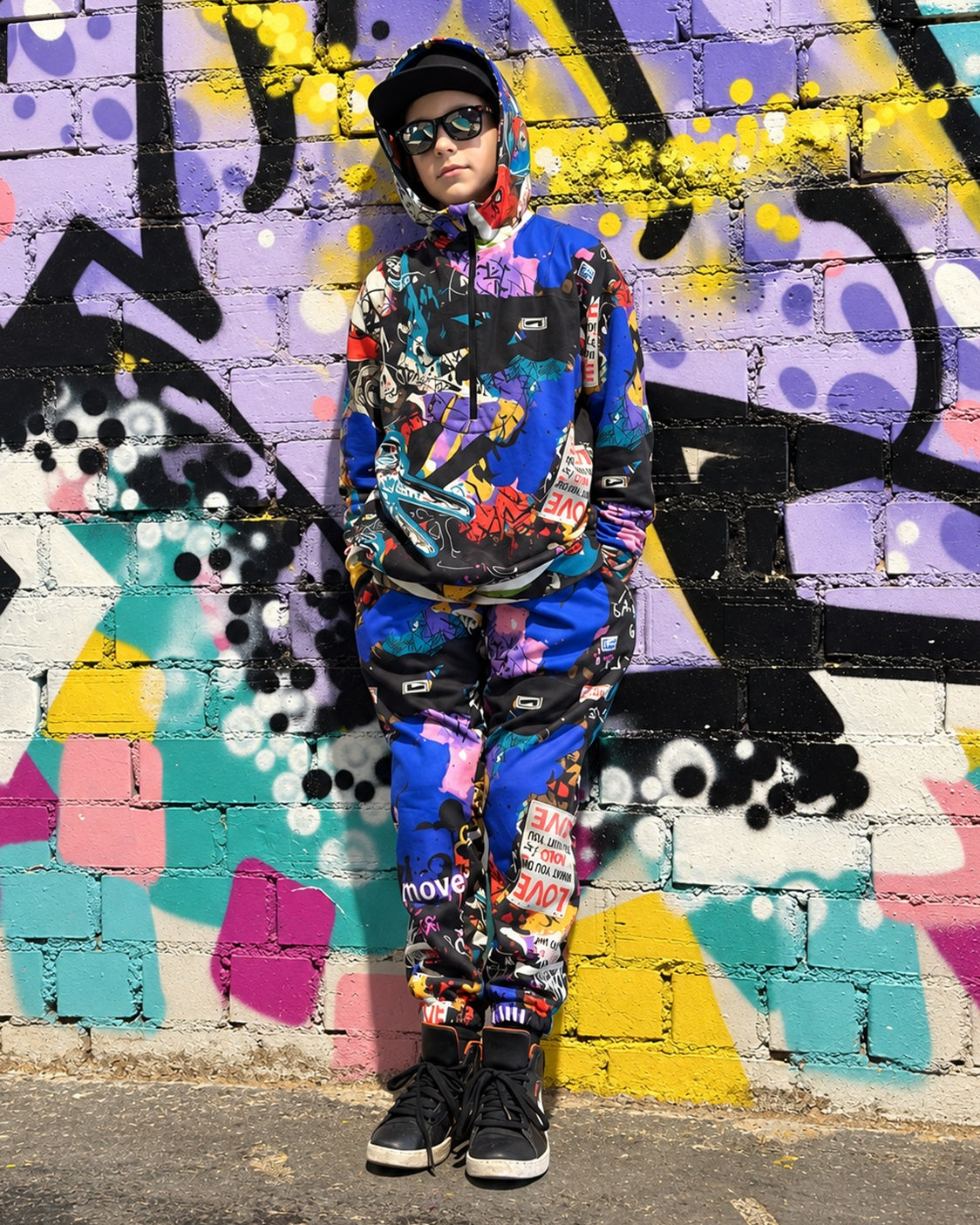 Child wearing MoveAddict Love and Peace print kids' joggers - front view