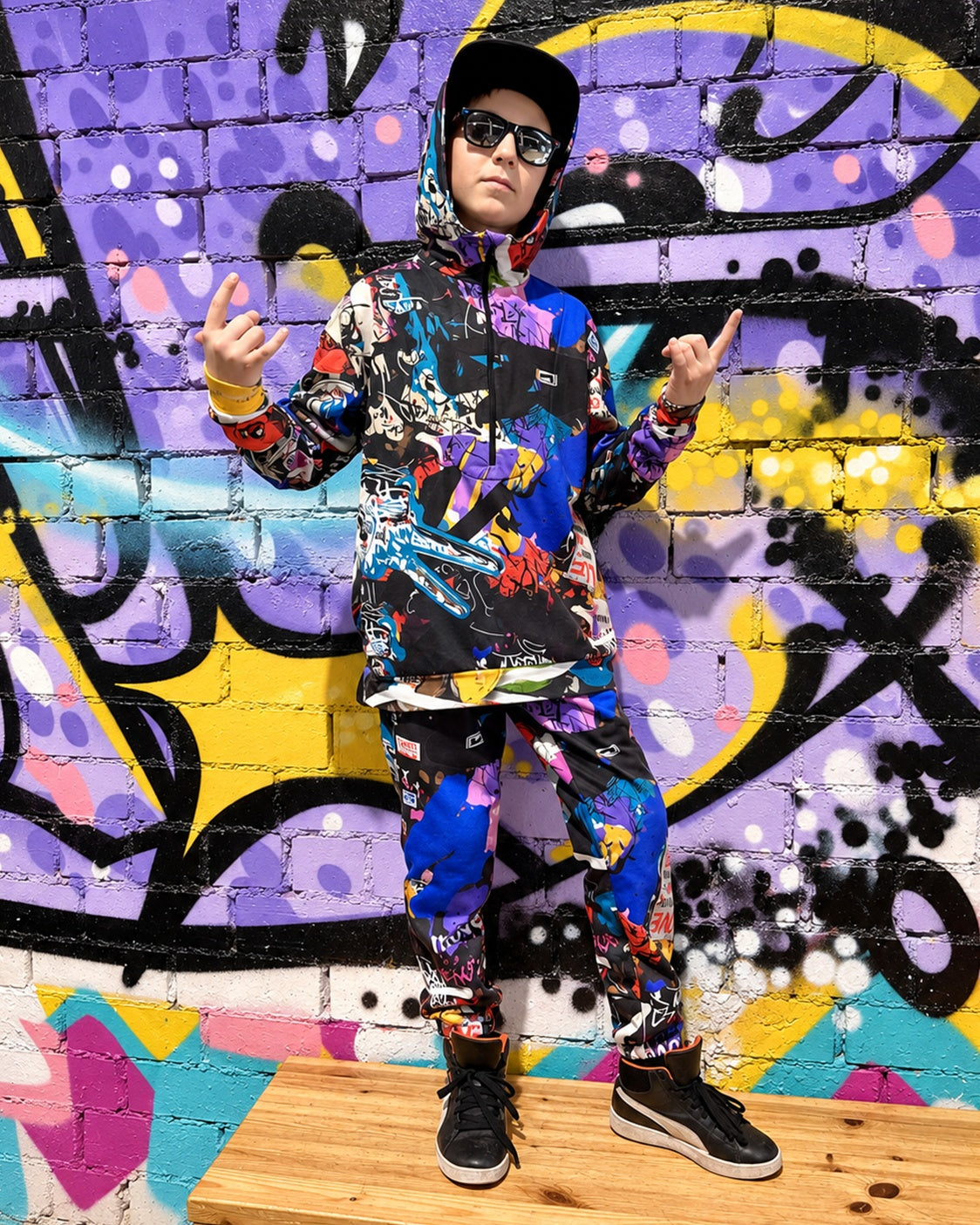 Child wearing MoveAddict Love and Peace print kids' joggers - full outfit with the matching set