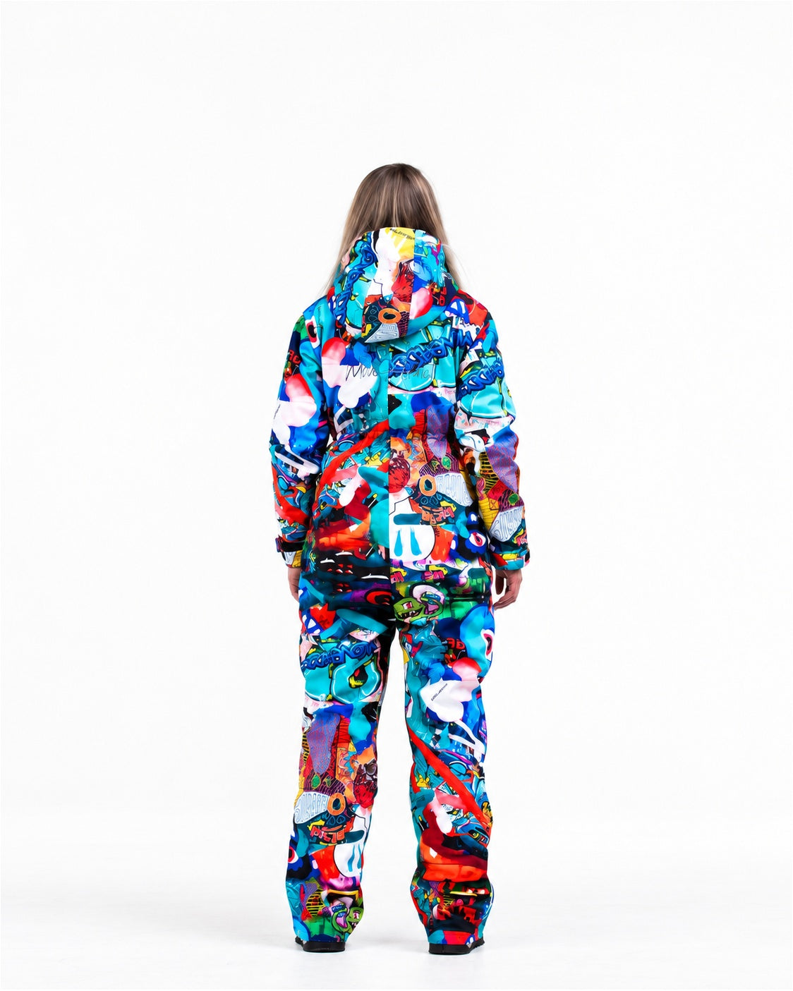 Woman wearing MoveAddict Monster Party print one-piece snowboard and ski suit – back view, studio photo