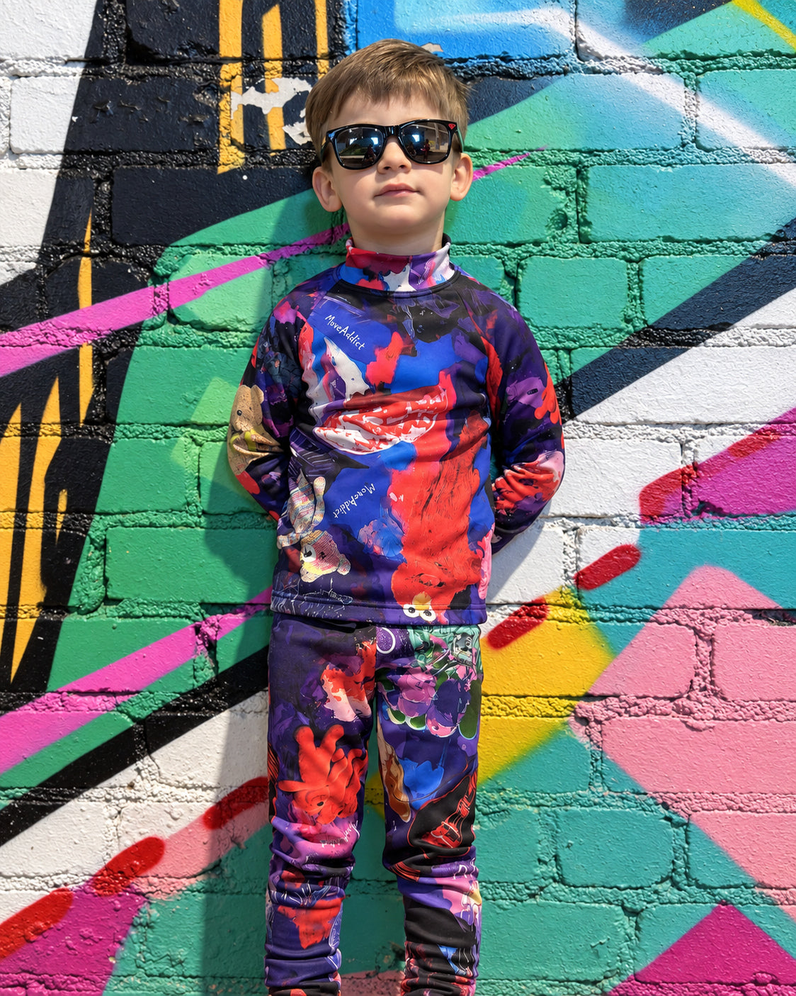 Child wearing MoveAddict Midnight Madness print kids' thermal top - front view