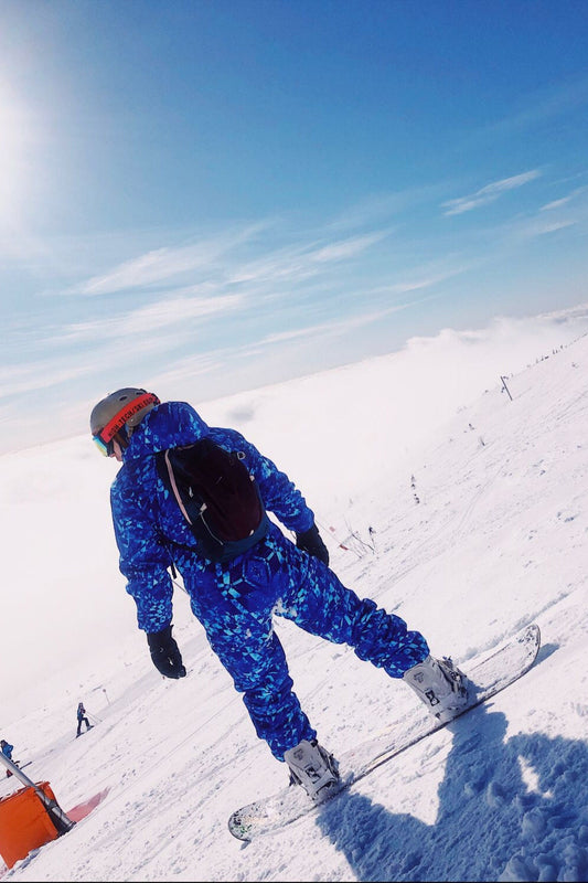 Man wearing MoveAddict Blue Graphic print one-piece snowboard and ski suit in the snow, photo 3