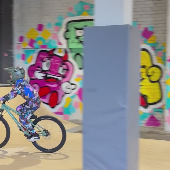 Kid riding a bike in MoveAddict Love and Peace print kids' hoodie and joggers — product video